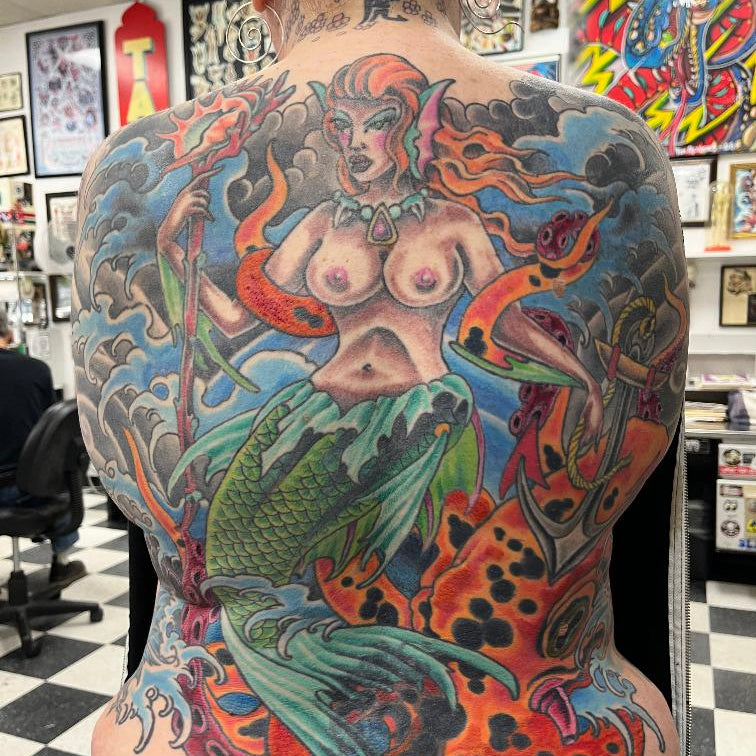 Backpiece tattoo of a topless mermaid by Julio avila